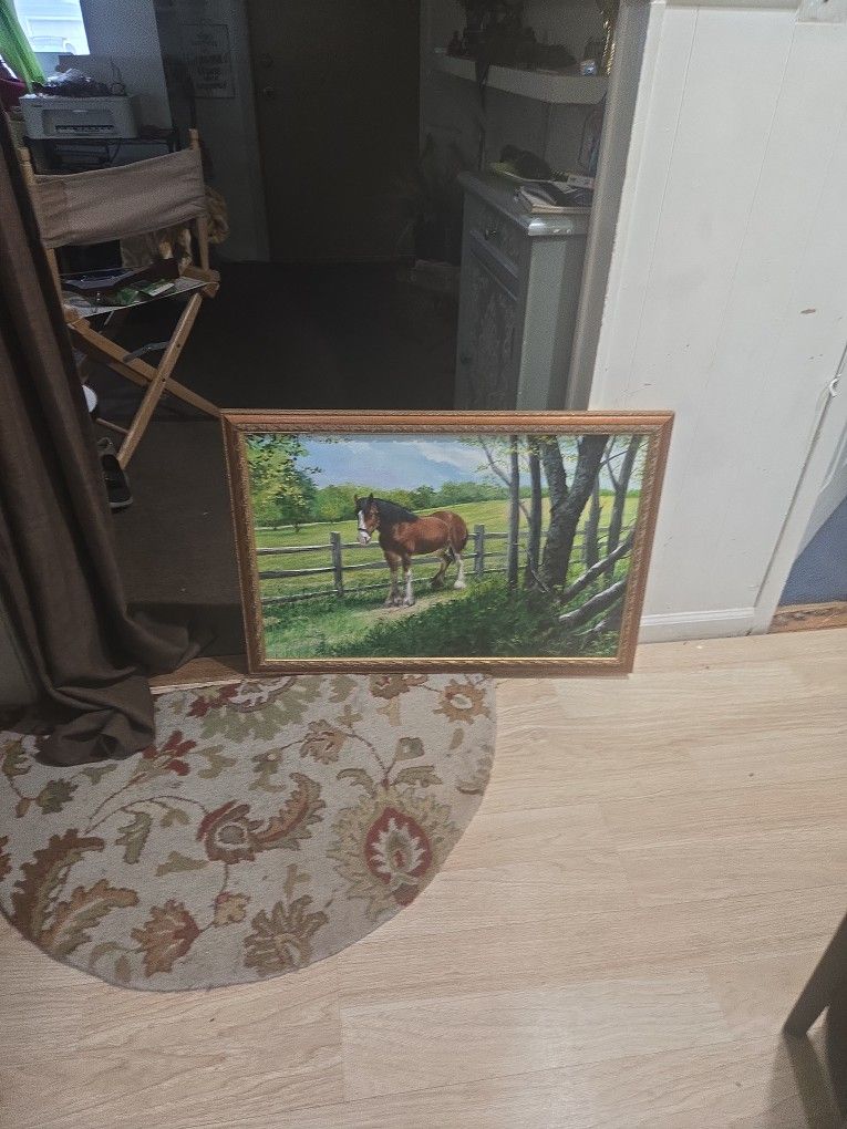 Brown Horse Pasture Setting With A Wooden Fence And Trees.