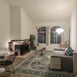 9’ x 12’3” green, yellow, beige, and orange patterned carpet