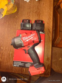 Milwaukee M18 fuel 1/2 High torque impact with 2 red lithium 5.0 AH batteries and. A charger a