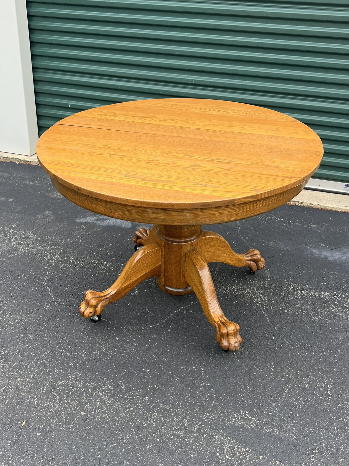 Antique tiger oak round kitchen table on wheels with one leaf 