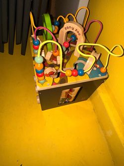 This is the B. toys Zany Zoo wooden activity cube featuring a top bead maze with colorful animal-shaped wooden pieces