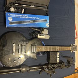 Microphones, Electric Guitar, A Mini 3 Speaker, Amplifier, And Mike Stanwood, Microphone Mount And Tablet Holder.