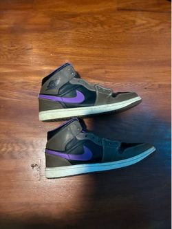 Nike Air Jordan 1 Mid sneakers in the "Palomino" or "Purple Mocha" colorway featuring brown and black tones with purple lining