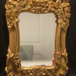 Vintage Ornate Wall Mirror 10”-14”. Beautiful heavy mirror is in good condition. Paper back of the mirror is not perfect condition, see photos 