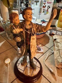 Beautiful Doctor statue holding a baby
