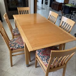 Expendable dining table with six chairs