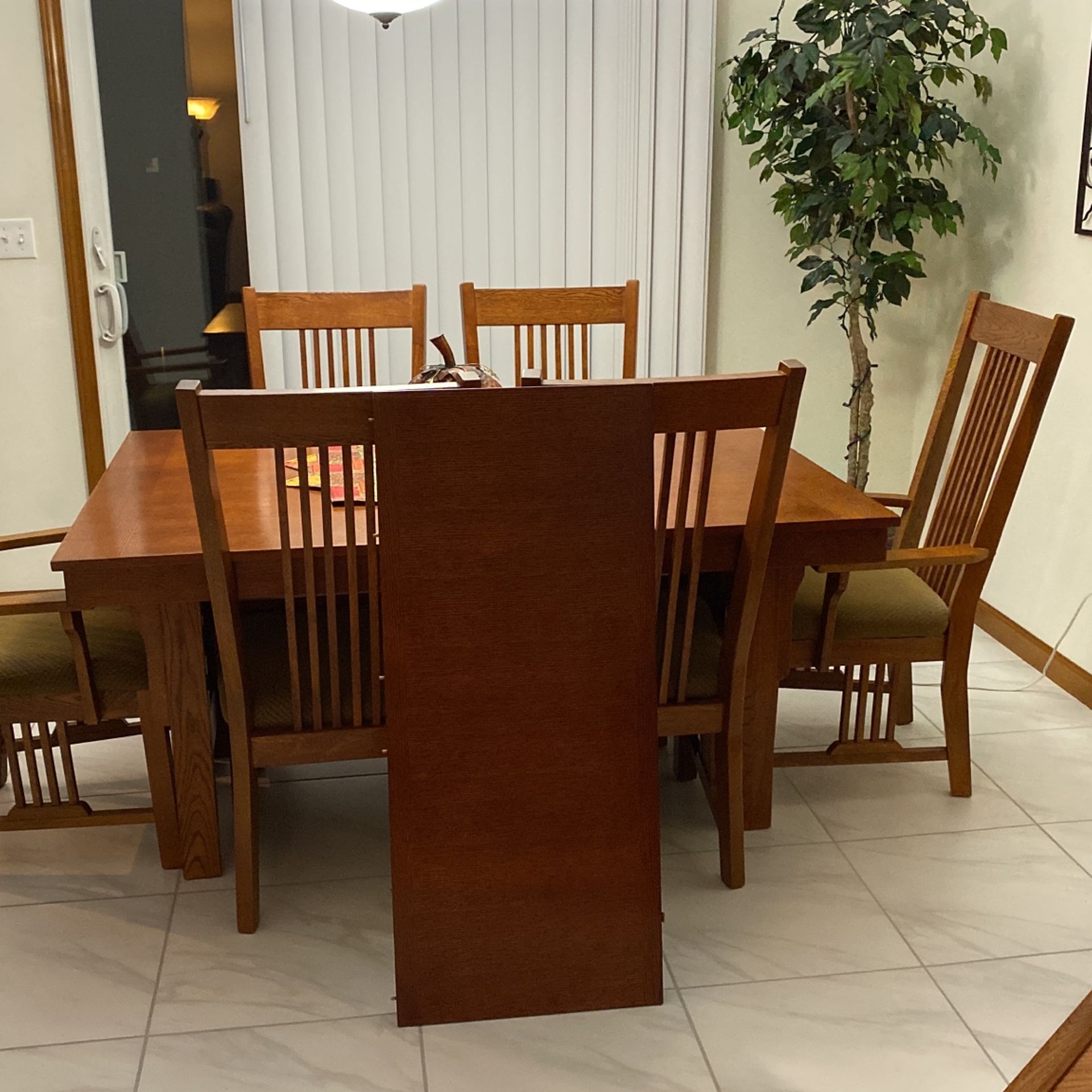 Oakmission Style  Table With 4 Regular Matching Chairs Are 60”L  x 42” W Without The Leaf   And 2 Captains Chairs  