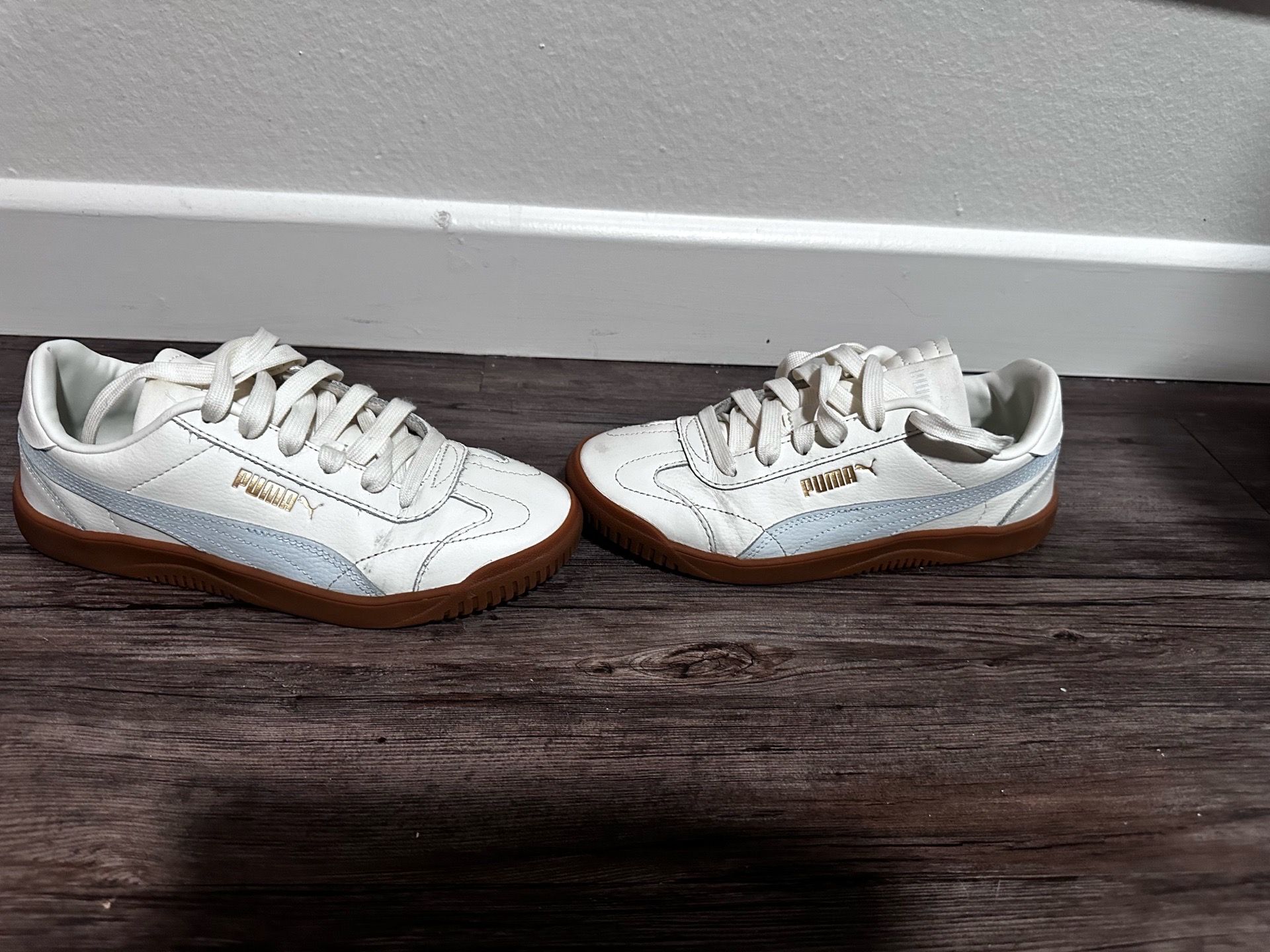 Puma white sneakers with gum soles and light blue accents