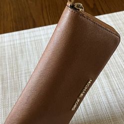 It’s A Michael Kors Wristlet Wallet It’s Barely used the color is brown