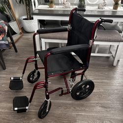 Medline Lightweight Foldable Transport Wheelchair with Handbrakes and 12-Inch Wheels, Red Frame, Black Upholstery
