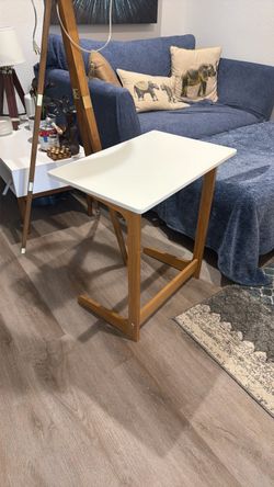 Wood table with lacquered top.