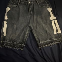 Black denim shorts with white skeleton design