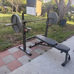 Bench press with Olympic bar and a pair of 45 pounds Olympic weights