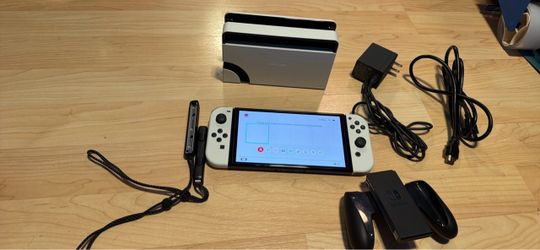 Nintendo switch oled with docking station, charger, hdmi, wrist straps and Joycon grip. No trades cash only check my other listings for more gaming st