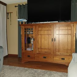 Solid wood, Entertaiment center. Glass shelves on the left side.  51.5" H 72 W, 24.5 "D