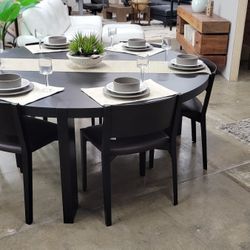 Round Carbone Oak Dining Table With 9 Black Modern Chairs