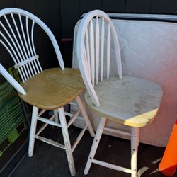 Two matching wooden chairs with white-painted backs and legs.