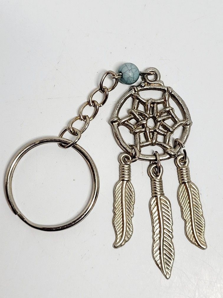 4" Dream Catcher Key Chain Feather Charm Bag Silver-toned Southwestern Jewelry.
The image shows a keychain featuring a dream catcher design. The dream