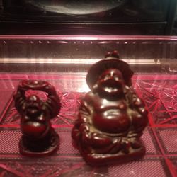 Vintage resin laughing Buddha figurines for sale.