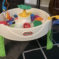 Little Tikes Activity Table Describe your item Interactive play table with various toys and activities.