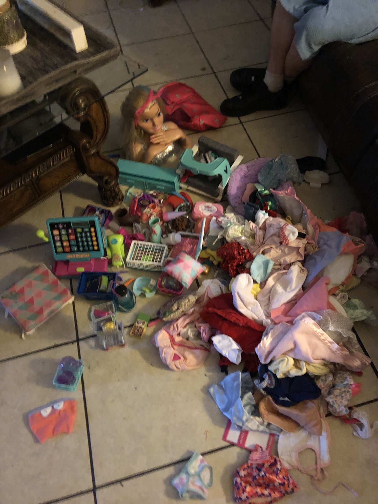 a whole bunch of baby clothes and american girl doll and barbie accessories