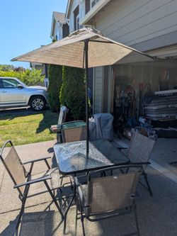 Patio table with chairs and unbrella