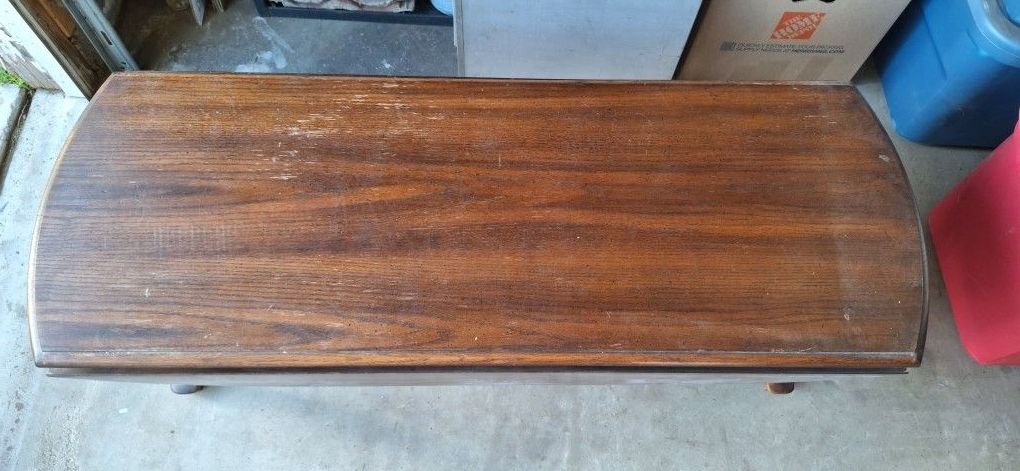 This Is An Old Drop Leaf Lions Feet Coffee Table Brown in color wood