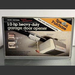 Unused 1/2-hp Sears/Craftsman garage door opener. Includes original packaging, accessories, owner's manual, and hardware. Box has damage.