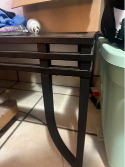 Black metal table with glass top