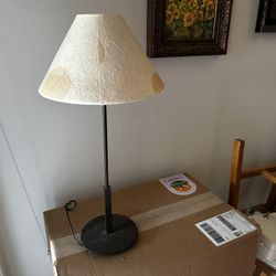 Vintage 21” tall dark bronze candle stick style table lamp with dried leaf shade. 