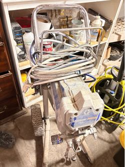 Graco Magnum ProX airless paint sprayer on a cart.
