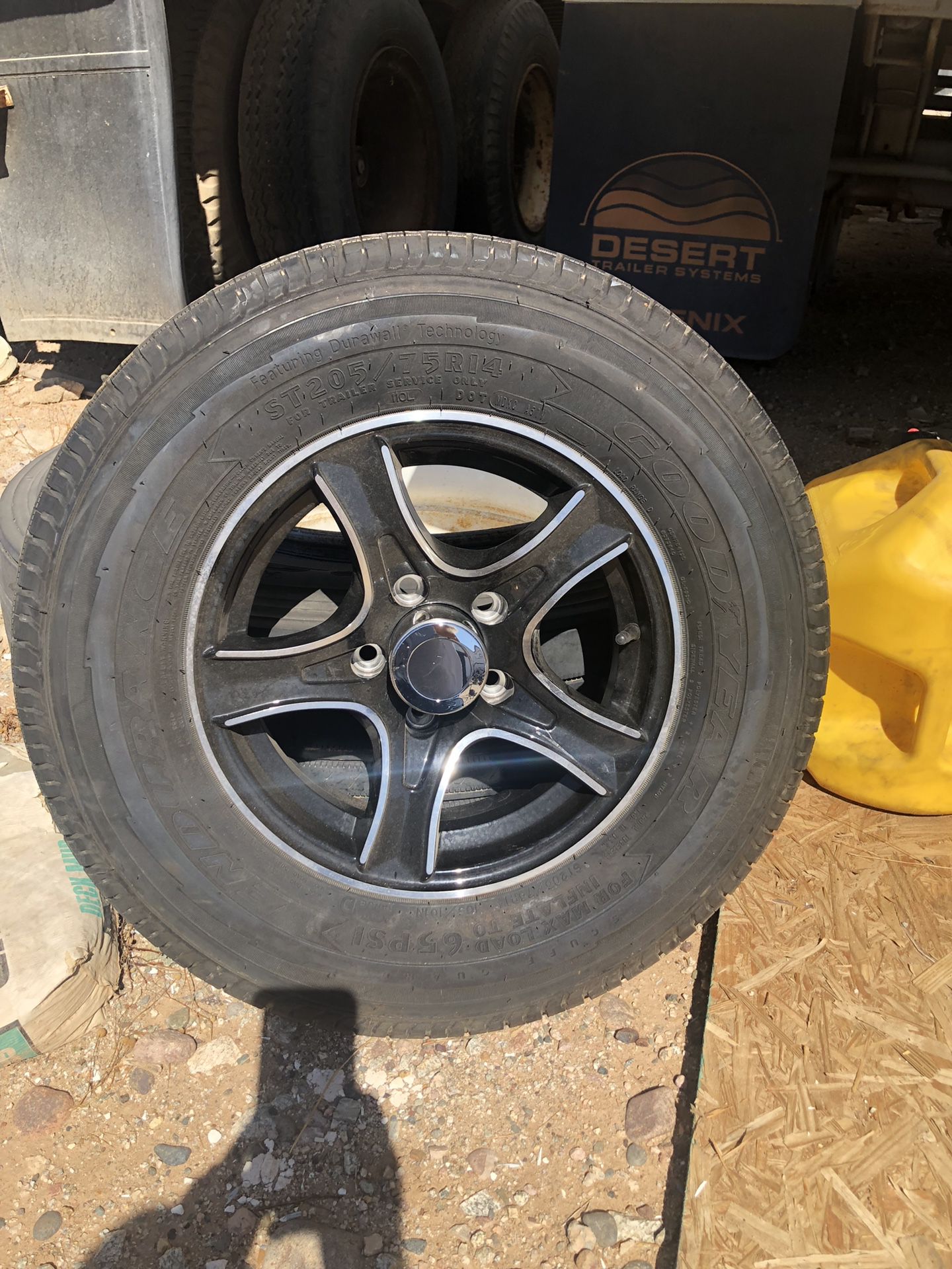 Brand new set of 5 rims and tires 205.75.14 Goodyear load D trailer lug nuts and center cap included