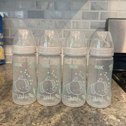 NUK Smooth Flow Anti Colic Baby Bottle, Comes With Extra Tops (FREE). 10 oz, 4 Pack, Elephant