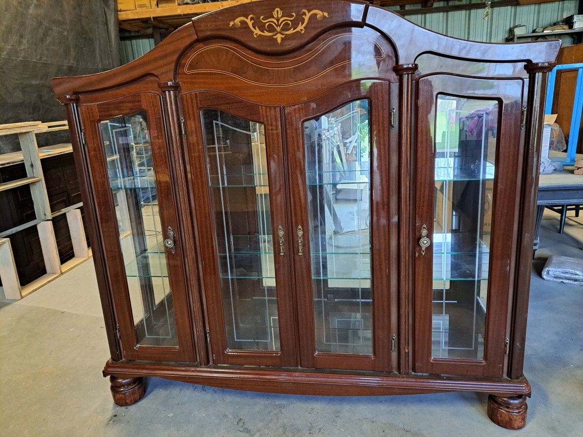 Beautiful Curio Cabinet with 2 glass shelves and  mirror back ground.