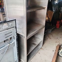 Two stainless steel metal cabinets 36 wide 31 tall 20 in deep wheel restaurant grade stainless steel or used for garage or shop has one shelf in each