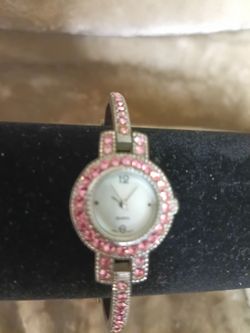 Vintage Classic Fashion Watch with pink crystals on band and bezel. Mother of pearl on face.