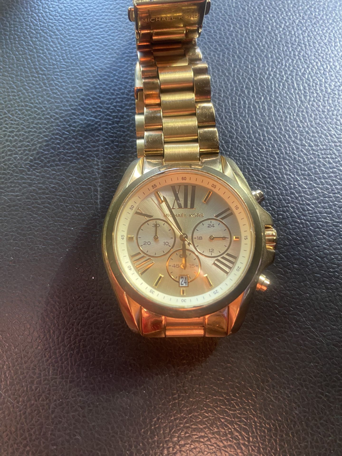 Michael Kors Lexington gold-tone stainless steel bracelet watch.