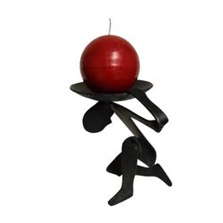 cast iron brutalist figurative candle holder man with world on shoulders
