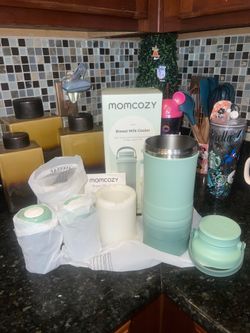 Momcozy breast milk cooler in mint green. Includes insulated cooler