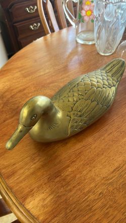 Metal duck statue and a metal duck tray could be used for jewelry rings Metal duck statue and a metal duck tray could be used for jewelry rings
