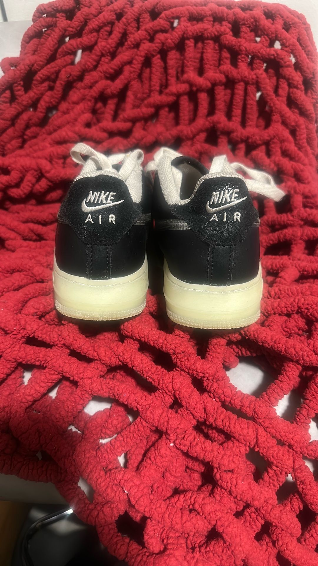 Nike Air Force 1 LV8 in a white and black colorway with a metallic silver swoosh and a translucent outsole