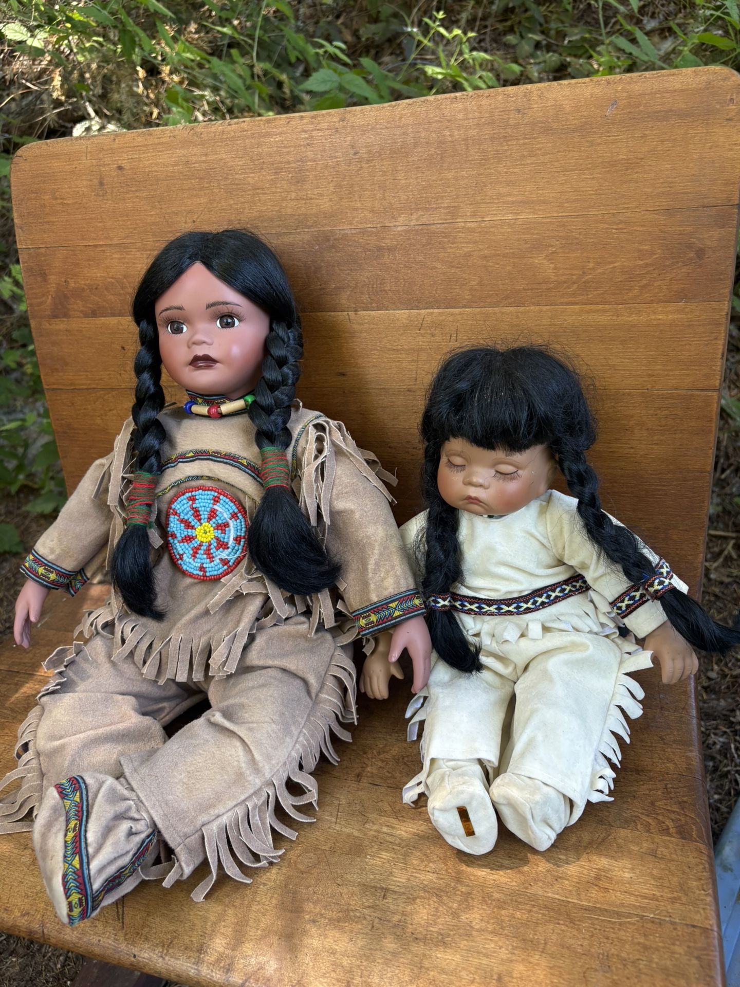 two Native American-inspired porcelain dolls