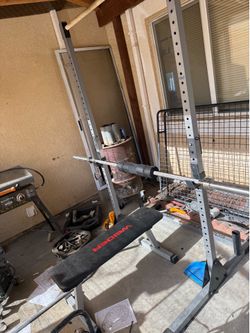 Weight bench with a full set of weights and extras
