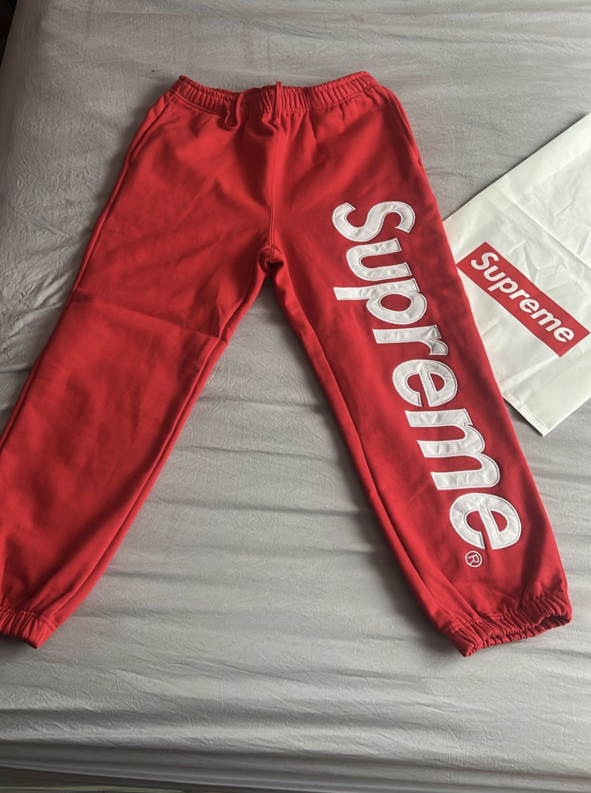 red and white supreme joggers size medium