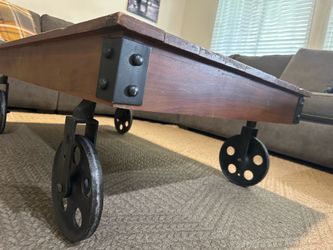 Industrial style coffee table with wheels
