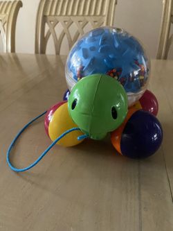 Toddler pulling along turtle