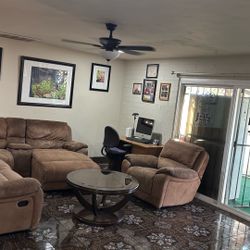 Brown sectional with chair and round coffee table w/ wheels