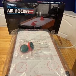 Portable tabletop air hockey game. 