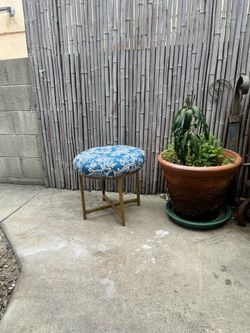 Ottoman with vintage upholstery newly applied