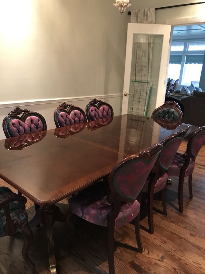 Antique red oak dining table with extensions. Two brocade arm chairs, 6 brocade chairs.